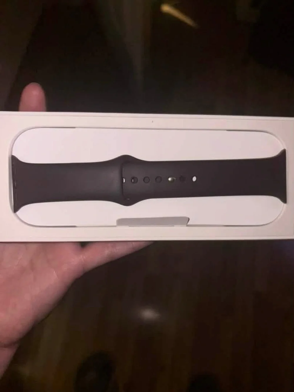 Apple SE GPS watch in grey aluminum case with maroon sports band.